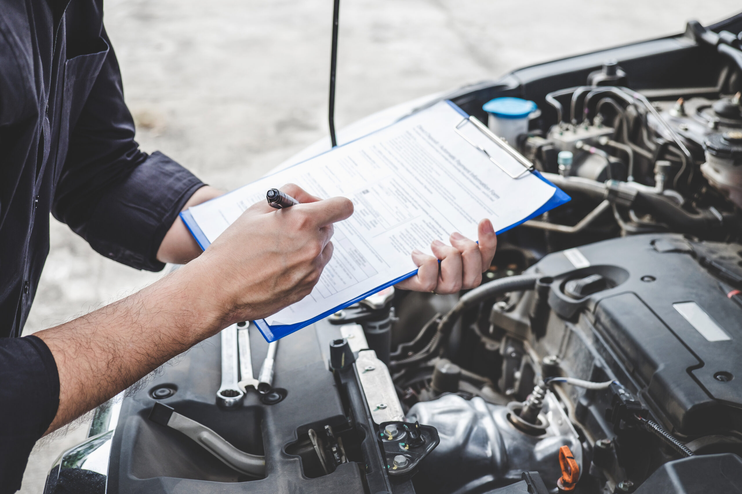 Mechanic showing a used car extended warranty similar to the one in the Paylink class action lawsuit