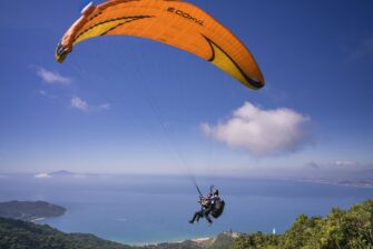 People tandum skydiving with parachute open